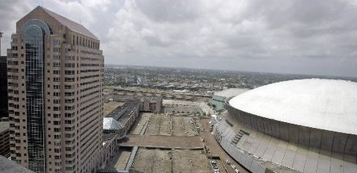 Aerial view of Benson Tower with parking and the Superdome to the right.